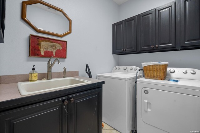 clothes washing area featuring cabinet space, a sink, and independent washer and dryer