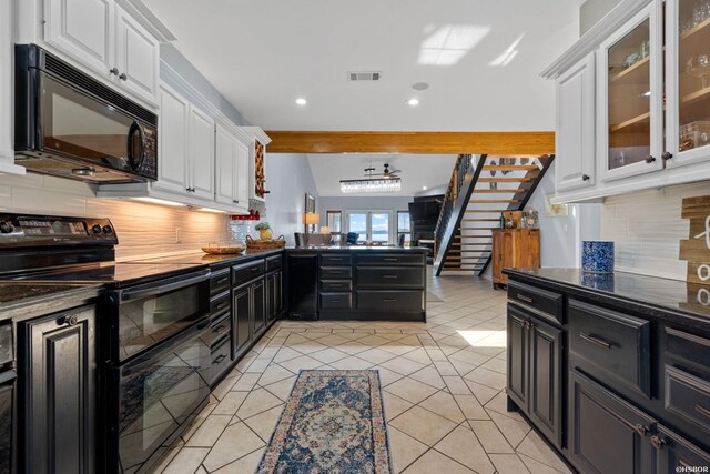 kitchen featuring visible vents, black appliances, glass insert cabinets, and white cabinets