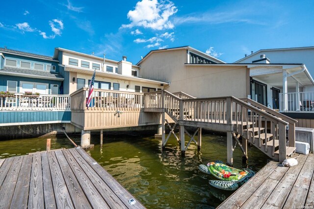 exterior space with a water view and stairs