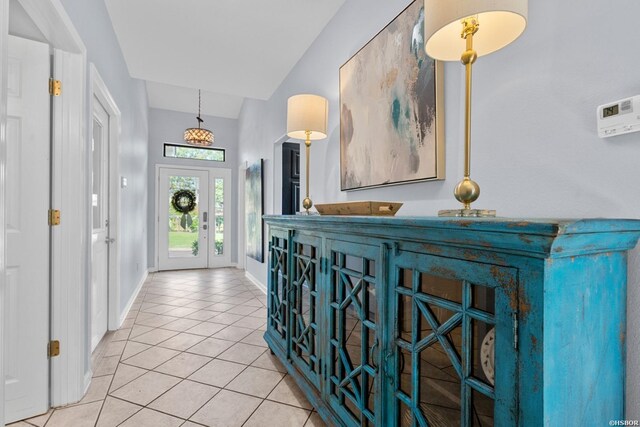 tiled foyer entrance with baseboards