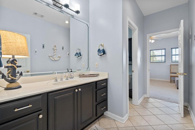 bathroom featuring tile patterned flooring, visible vents, baseboards, and vanity