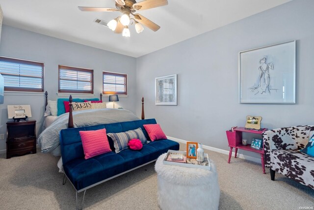 carpeted bedroom with visible vents, ceiling fan, and baseboards