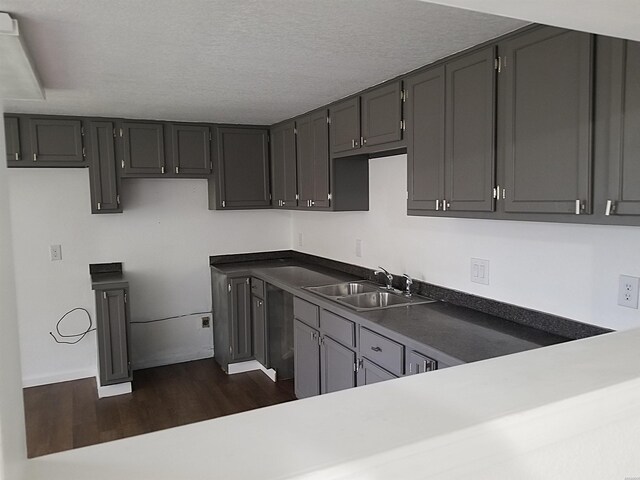 186 Vanadium Cir, Hot Springs, AR 71901 - kitchen featuring dark wood-style floors, a textured ceiling, a sink, and dark countertops