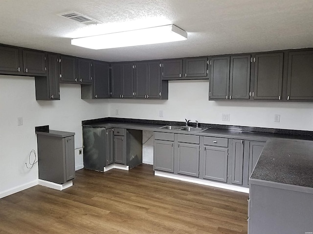 186 Vanadium Cir, Hot Springs, AR 71901 - kitchen featuring dark wood finished floors, dark countertops, a sink, baseboards, and visible vents