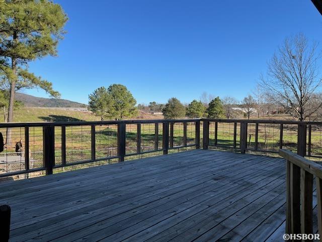 wooden terrace featuring a rural view