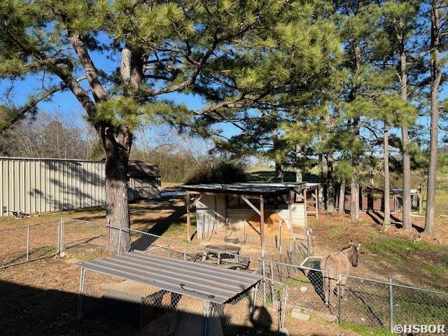 view of yard with fence and an outbuilding