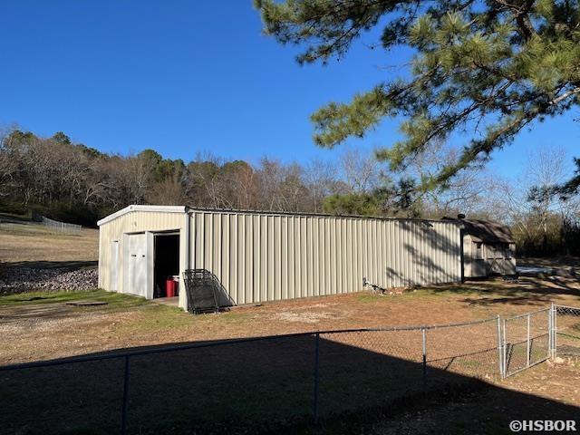 view of outbuilding with an outbuilding and fence