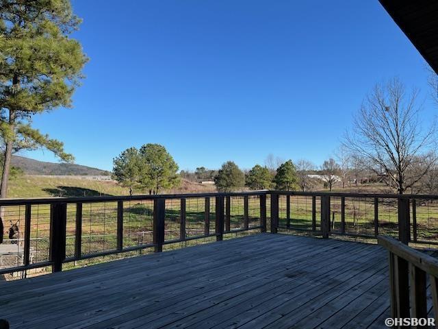 wooden deck with a rural view