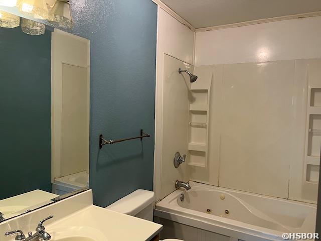 full bath with toilet,  shower combination, and vanity