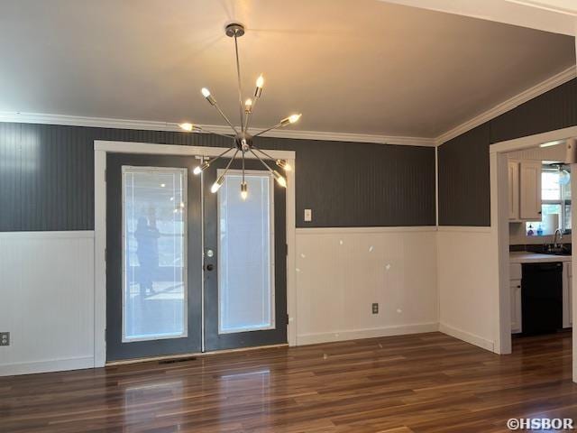 unfurnished dining area with a chandelier, a sink, wood finished floors, and crown molding