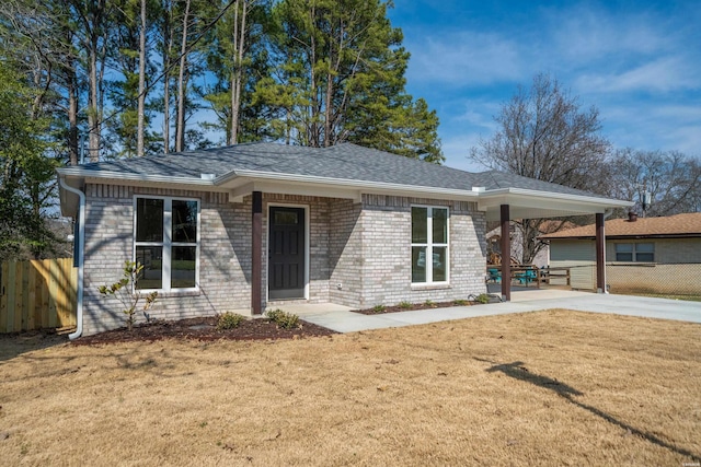 ranch-style house with a carport, fence, concrete driveway, and brick siding