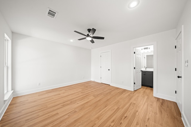 unfurnished bedroom with connected bathroom, recessed lighting, visible vents, baseboards, and light wood finished floors