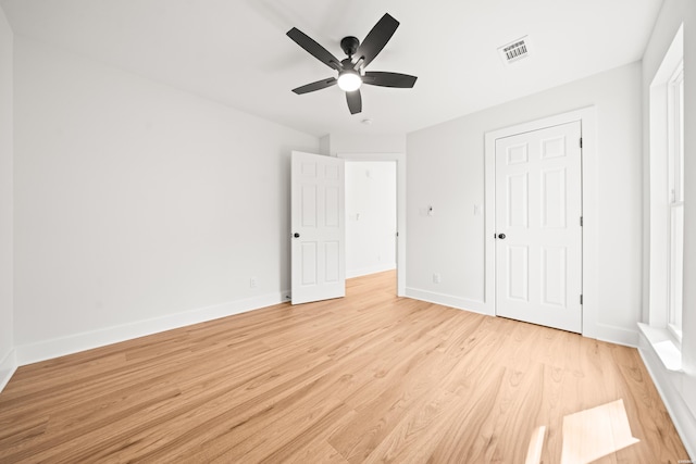 unfurnished bedroom featuring visible vents, ceiling fan, light wood-style flooring, and baseboards