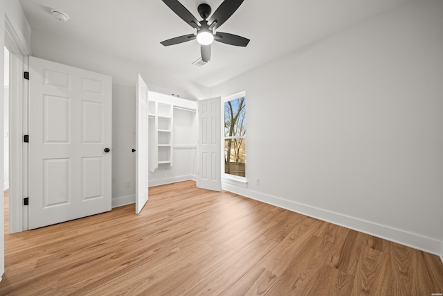 unfurnished bedroom with ceiling fan, light wood-style flooring, and baseboards