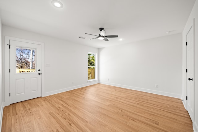 empty room with light wood-style flooring, visible vents, baseboards, and recessed lighting