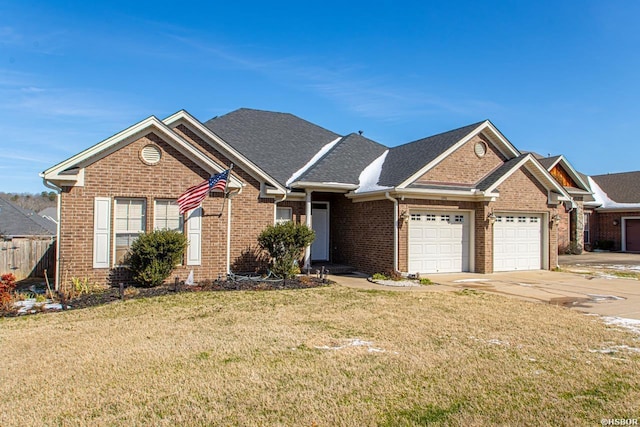 view of front of home featuring a garage, driveway, brick siding, and a front yard