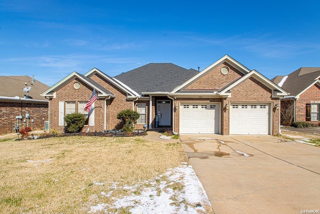 view of front of house with concrete driveway, brick siding, a front lawn, and an attached garage