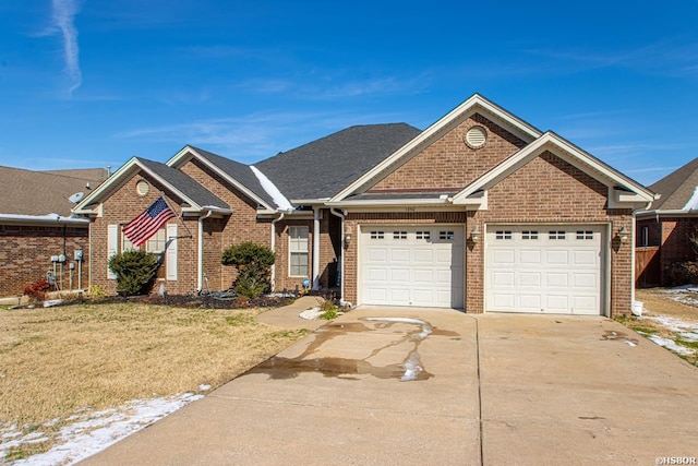 view of front facade featuring a garage, concrete driveway, brick siding, and a front lawn