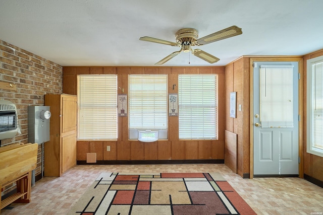 unfurnished sunroom featuring heating unit and plenty of natural light