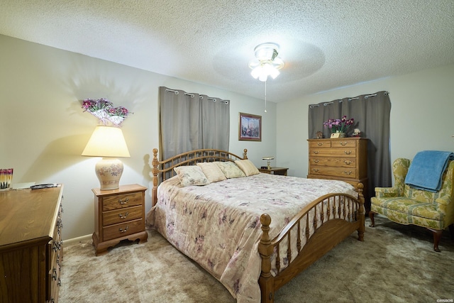 bedroom with light colored carpet, a textured ceiling, and a ceiling fan