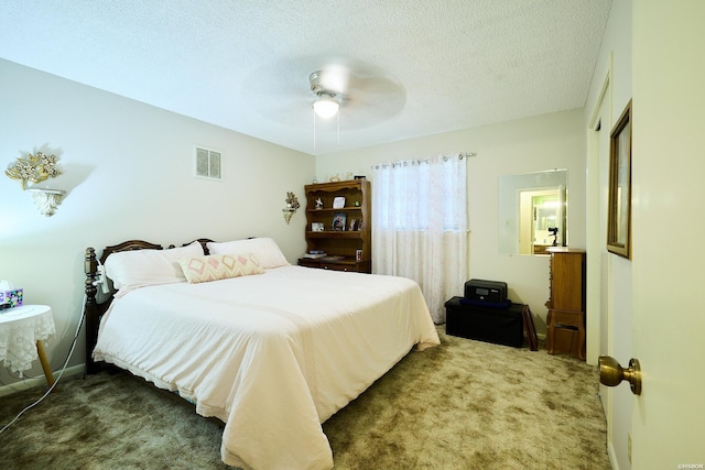 carpeted bedroom with baseboards, ceiling fan, visible vents, and a textured ceiling