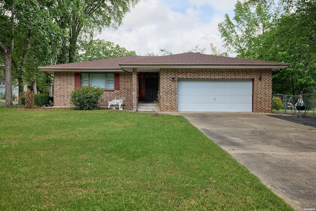 single story home featuring fence, brick siding, driveway, a garage, and a front lawn