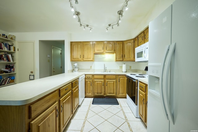 kitchen featuring a peninsula, light tile patterned floors, a sink, brown cabinetry, and white appliances