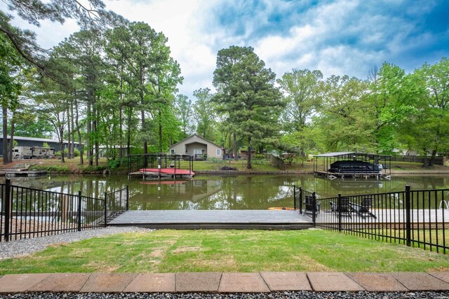 exterior space featuring fence and a dock