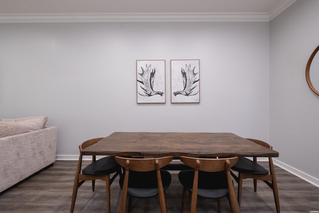 dining room featuring crown molding, dark wood finished floors, and baseboards