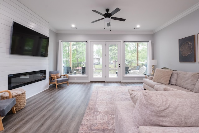 living room featuring recessed lighting, a large fireplace, wood finished floors, and plenty of natural light