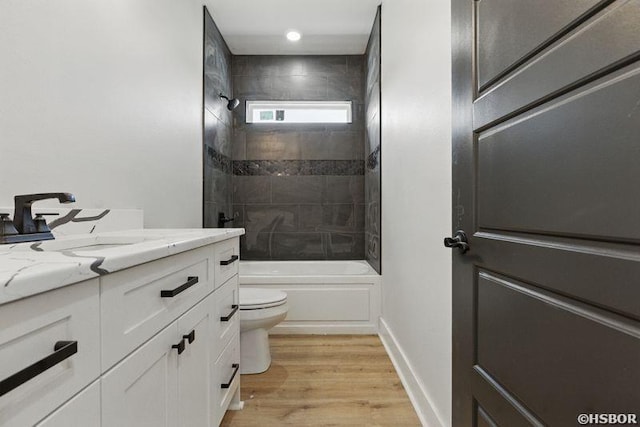 132 Lombard Ct, Hot Springs, AR 71901 - bathroom with baseboards, shower / washtub combination, toilet, vanity, and wood finished floors