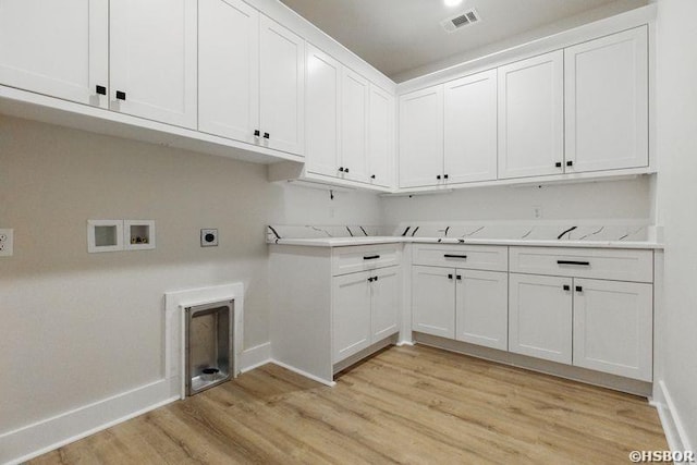 132 Lombard Ct, Hot Springs, AR 71901 - laundry area featuring hookup for an electric dryer, light wood-type flooring, washer hookup, visible vents, and cabinet space