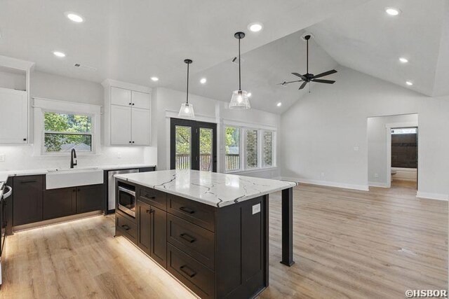 132 Lombard Ct, Hot Springs, AR 71901 - kitchen with a sink, ceiling fan, stainless steel microwave, white cabinetry, and light wood finished floors
