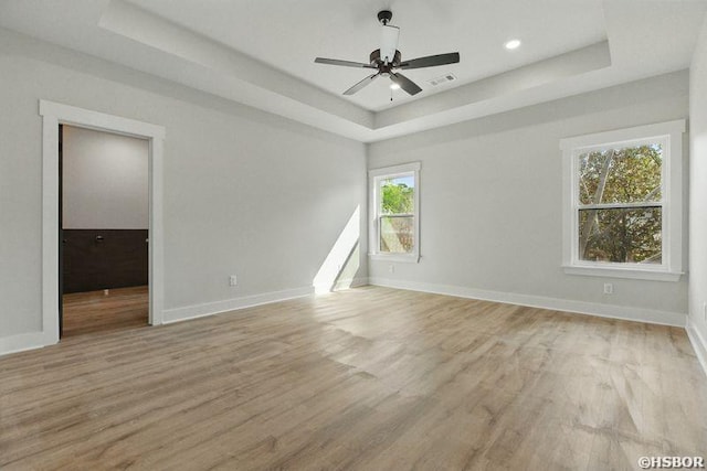 132 Lombard Ct, Hot Springs, AR 71901 - spare room with light wood-type flooring, visible vents, a tray ceiling, and baseboards