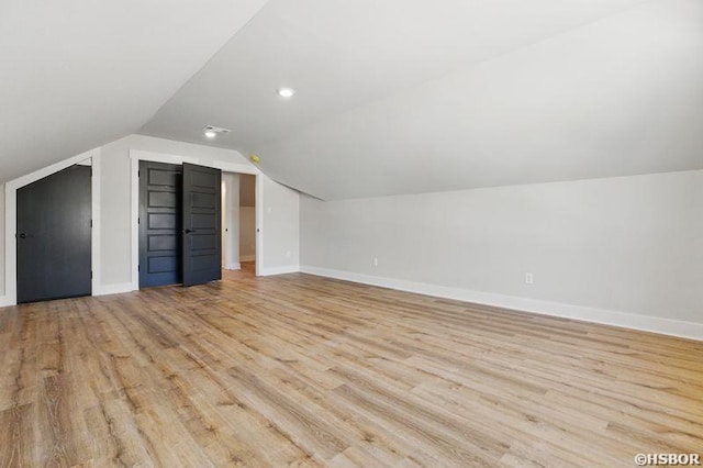 132 Lombard Ct, Hot Springs, AR 71901 - additional living space with vaulted ceiling, light wood-type flooring, and baseboards