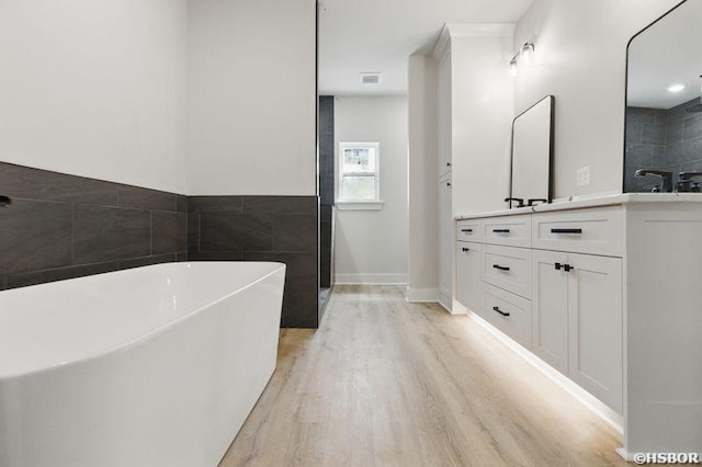 132 Lombard Ct, Hot Springs, AR 71901 - bathroom featuring a freestanding bath, wood finished floors, vanity, and walk in shower