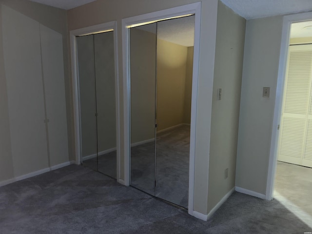 142 Lake Hamilton Dr Unit 410, Hot Springs, AR 71913 - unfurnished bedroom featuring two closets, carpet flooring, and baseboards