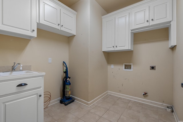 washroom with baseboards, washer hookup, light tile patterned floors, cabinet space, and hookup for an electric dryer