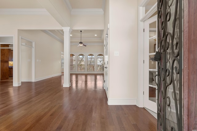 entryway featuring decorative columns, a ceiling fan, dark wood-style floors, and crown molding