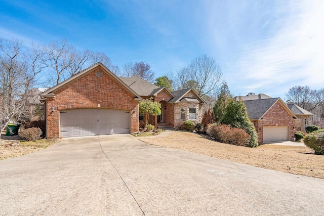 view of front facade featuring a garage, brick siding, and driveway