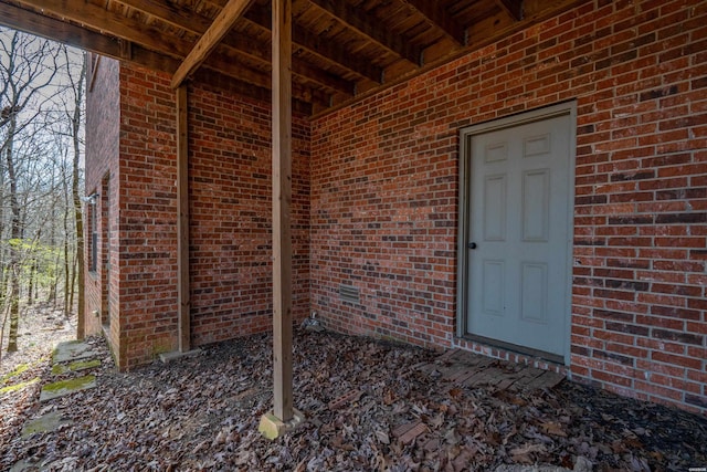 doorway to property featuring brick siding