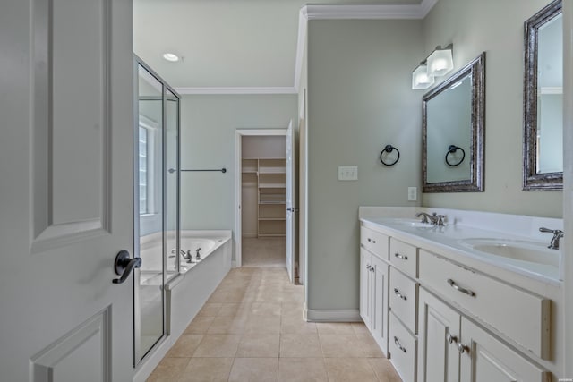 bathroom featuring a spacious closet, crown molding, a bath, tile patterned floors, and a sink