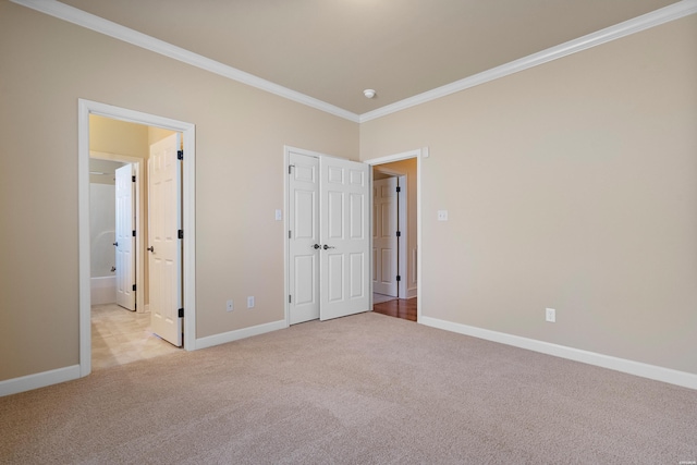 unfurnished bedroom featuring baseboards, carpet floors, and crown molding