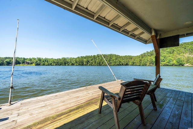 dock area featuring a water view and a forest view