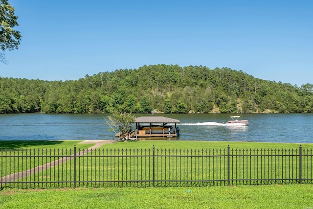 view of water feature featuring fence and a view of trees