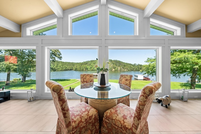 sunroom with a water view and lofted ceiling with beams