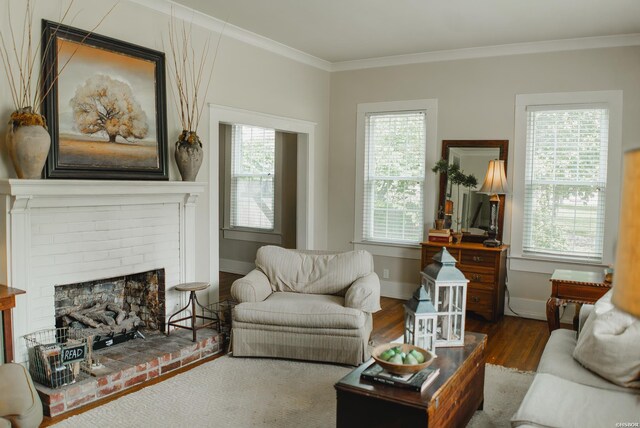 living room with baseboards, a fireplace, ornamental molding, and dark wood-style flooring