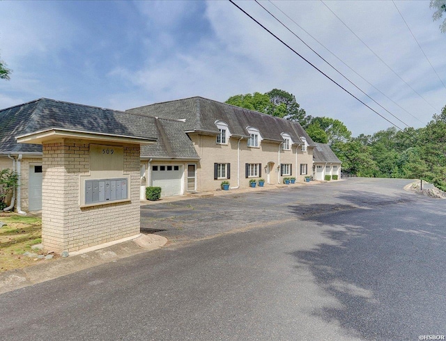 509 Belvedere Dr Unit B4, Hot Springs, AR 71901 - french country inspired facade featuring roof with shingles, mansard roof, brick siding, and a garage