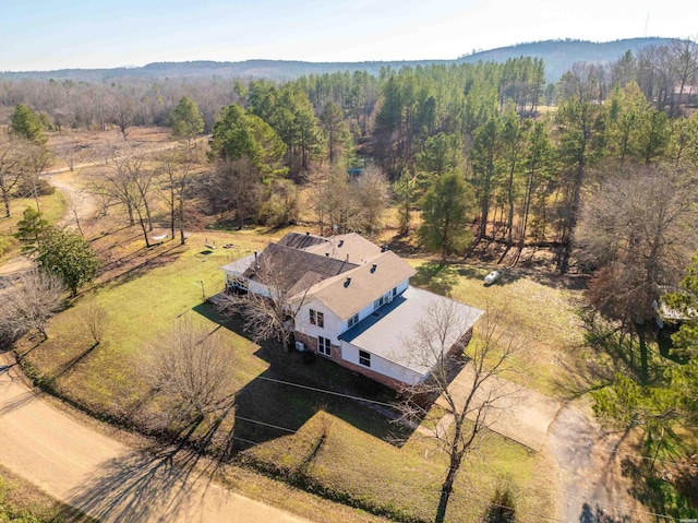 birds eye view of property featuring a wooded view