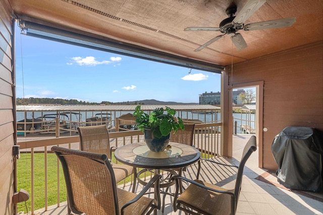 exterior space with a water view and ceiling fan